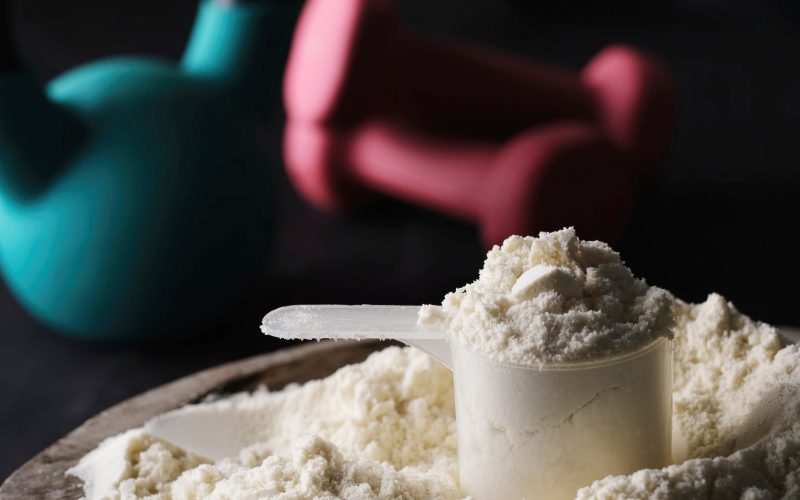 measuring spoon with dry sports protein rotates on a board